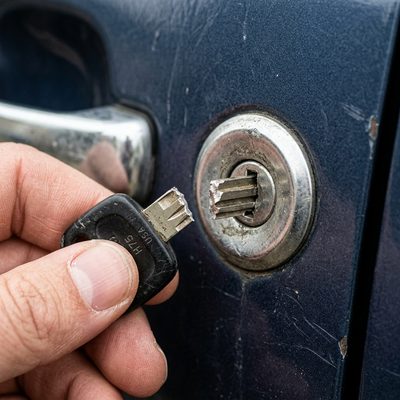 Broken car key fragment stuck inside a car door lock