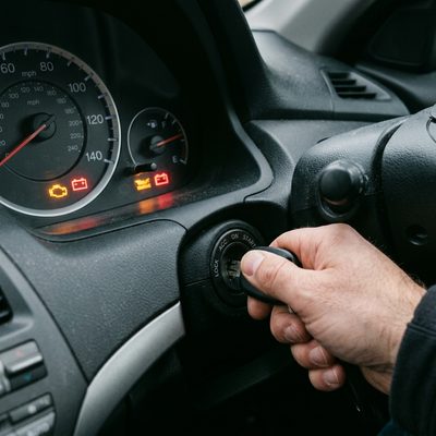 Car dashboard warning lights illuminated while key is turned to start