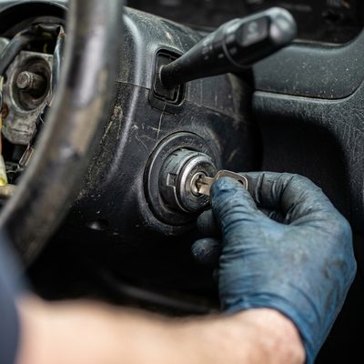 Wobbly loose car ignition being inspected by a mechanic